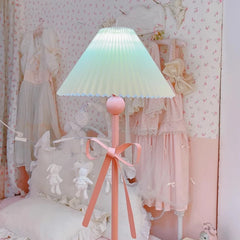 Pastel-colored lamp with a pleated shade in a decorative room.