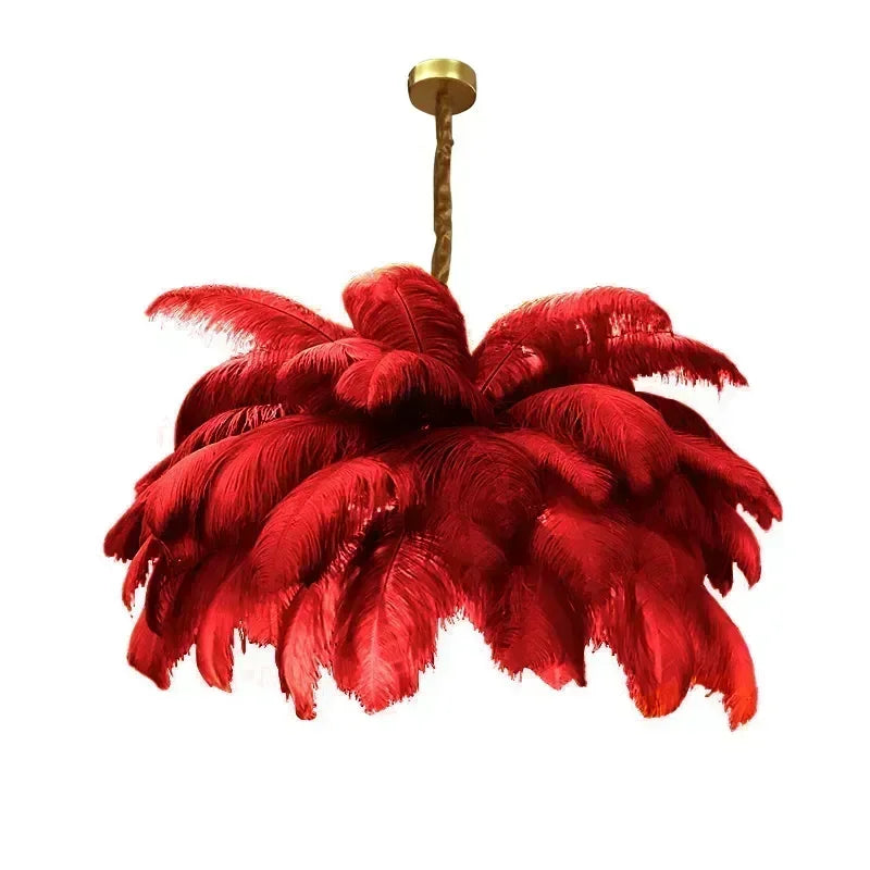 Red feathered chandelier with gold fixture on a white background