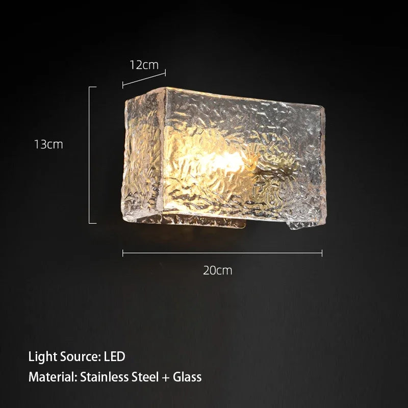 Cube-shaped wall light with dimensions and material details on a black background