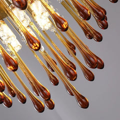 Close-up of a chandelier with glass droplet design on a gray background