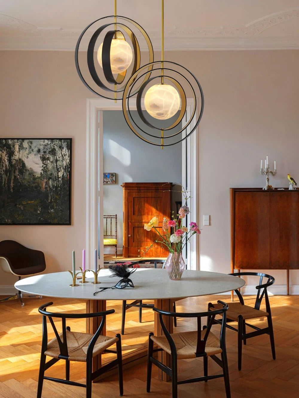 Dining room with round table, chairs, and decorative elements.