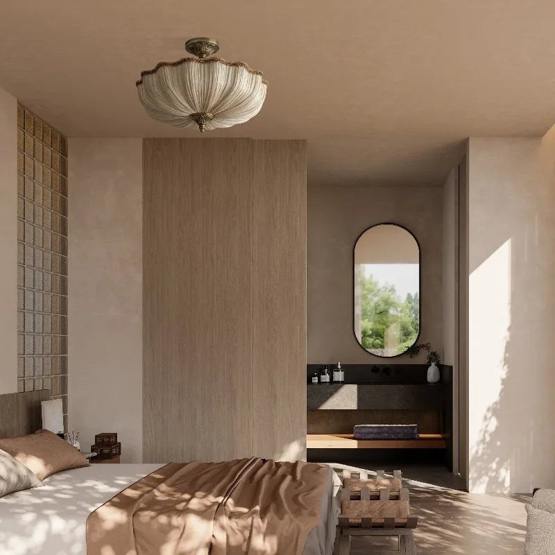 A bedroom interior featuring a beige fabric pleated semi-flush ceiling light above a bed