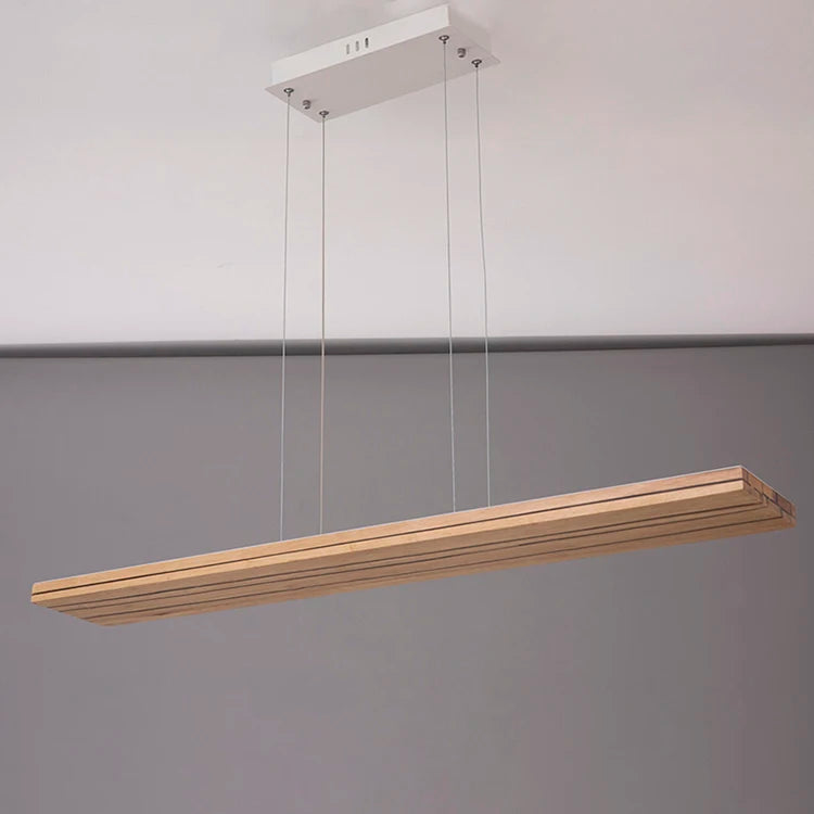 Wooden pendant light fixture hanging against a gray background