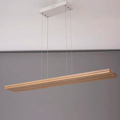 Wooden pendant light fixture hanging against a gray background