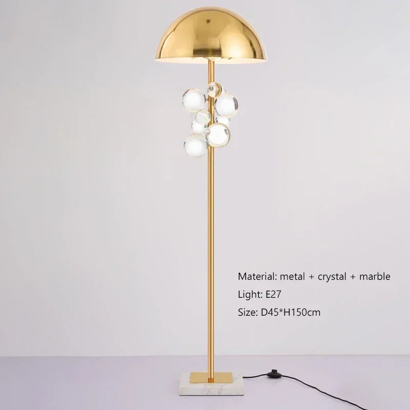 Gold dome floor lamp with a cluster of clear crystal accents, on a white background.
