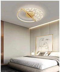 Modern bedroom with a ceiling light fixture and abstract wall art.