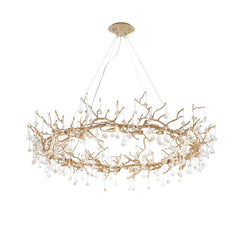 Gold chandelier with branch-like design on a white background