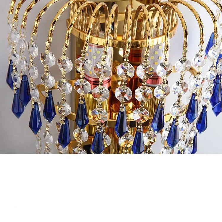 Gold and blue crystal chandelier with text on a gray background