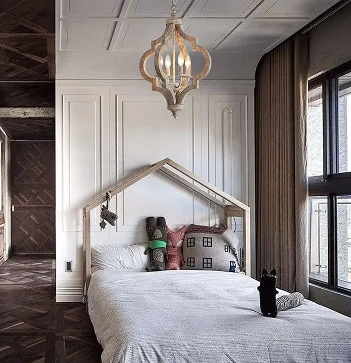 Children's bedroom with a house-shaped bed and decorative pillows.