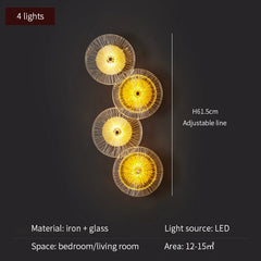 Wall-mounted light fixture with four illuminated circular lights on a dark background.