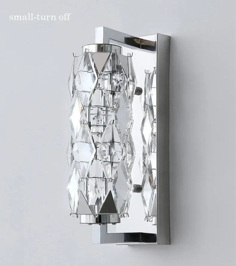 Modern wall sconce with crystal accents on a gray background