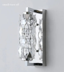 Modern wall sconce with crystal accents on a gray background