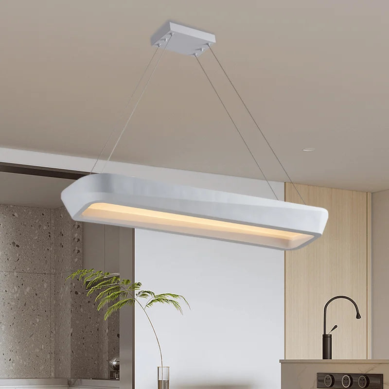 Modern pendant light hanging in a kitchen with neutral decor
