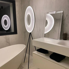 Modern bathroom with a circular light fixture and mirror.