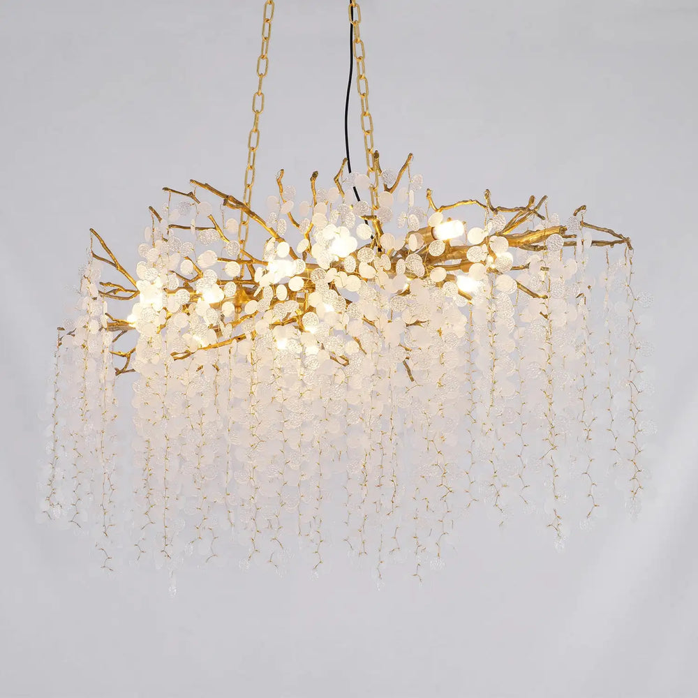 Chandelier with gold branches and white beads on a gray background