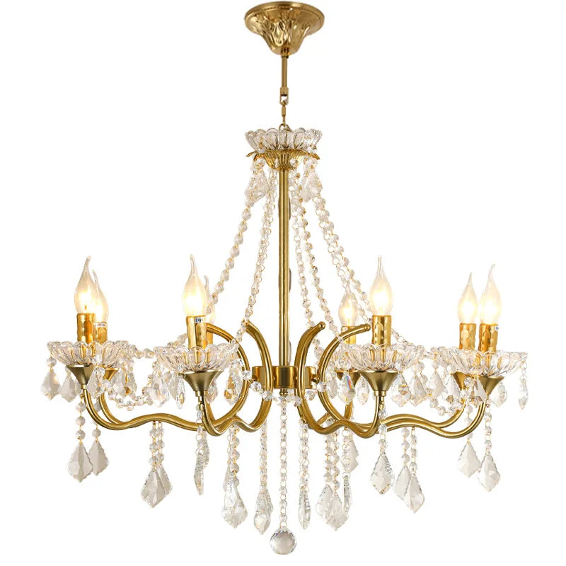 Gold chandelier with crystal accents on a white background