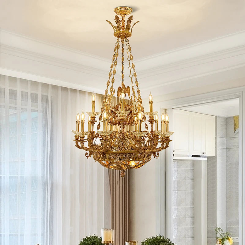 Gold candelabra crystal chandelier with a window and cabinetry in the background.