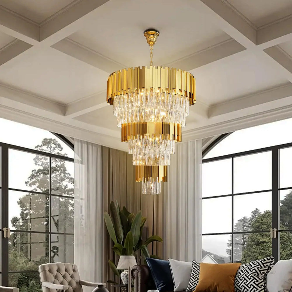 Gold chandelier hanging in a living room with large windows