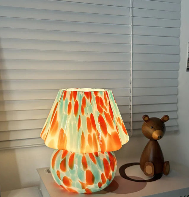 Colorful lamp with a teddy bear figurine on a shelf