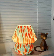 Colorful lamp with a teddy bear figurine on a shelf