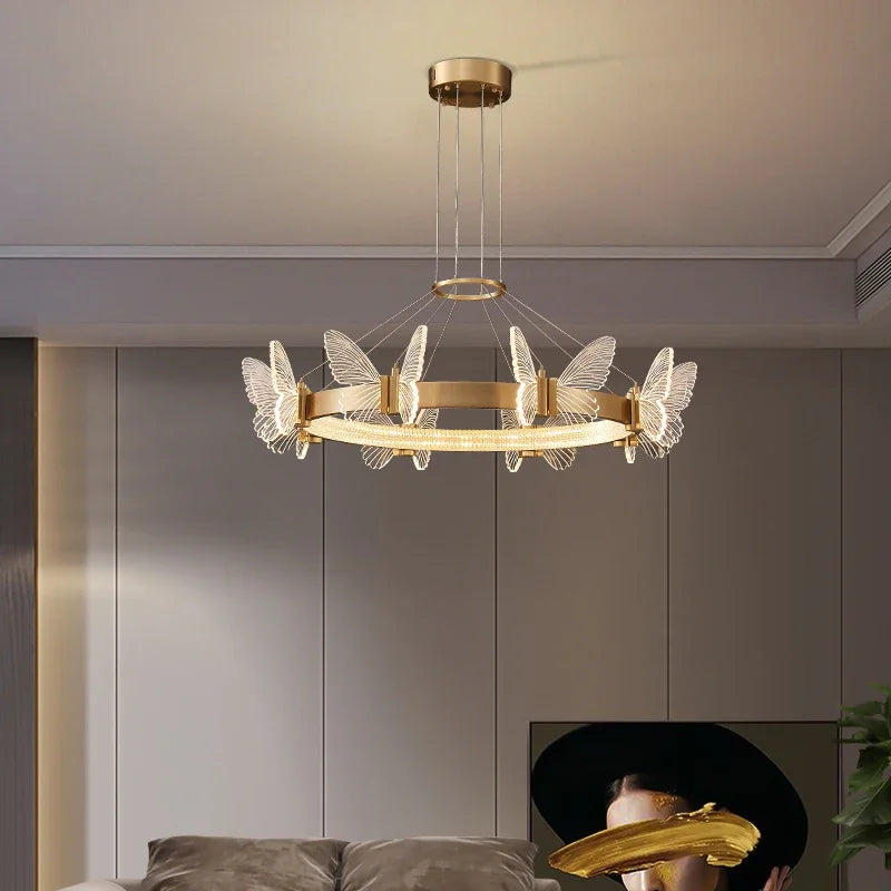 Close-up of the gold butterfly and clear crystal details on the ring pendant light.