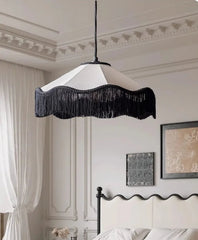Bedroom with a canopy bed and decorative lamp.