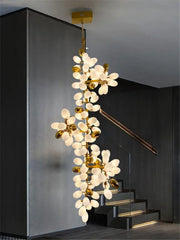 Decorative chandelier hanging in a modern interior setting with stairs.