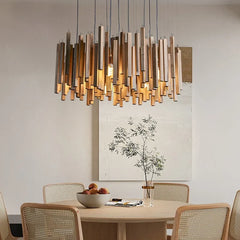 Close-up of a wooden stick chandelier with neutral light, hanging over a round table
