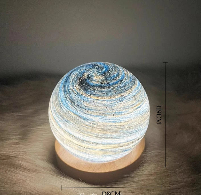 Decorative lamp with swirling design on a textured surface