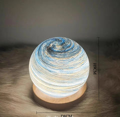 Decorative lamp with swirling design on a textured surface