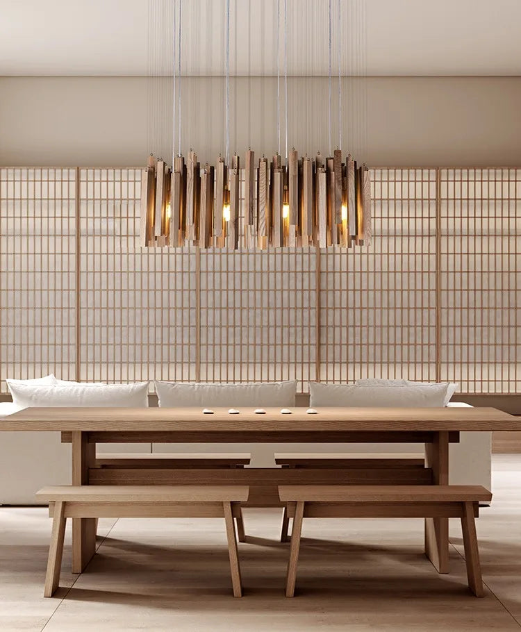 Modern dining room with wooden table, chairs, and benches under a decorative chandelier.