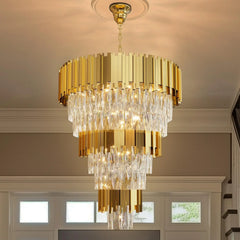 Gold chandelier hanging in a room with windows