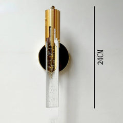 Wall sconce with gold and black design on a white wall, labeled '24CM'.