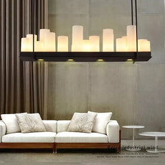 Modern chandelier hanging above a sofa in a living room setting.