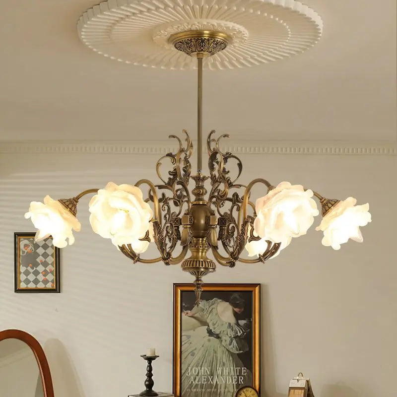 Polished copper floral chandelier with multiple rose-shaped glass shades, highlighting the central column and decorative arms.