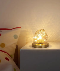 Decorative lamp on a nightstand with a polka dot pillow in the background