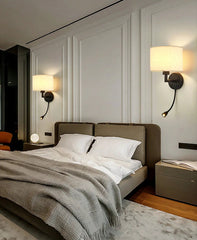 Modern bedroom with a bed, nightstands, and wall lamps.