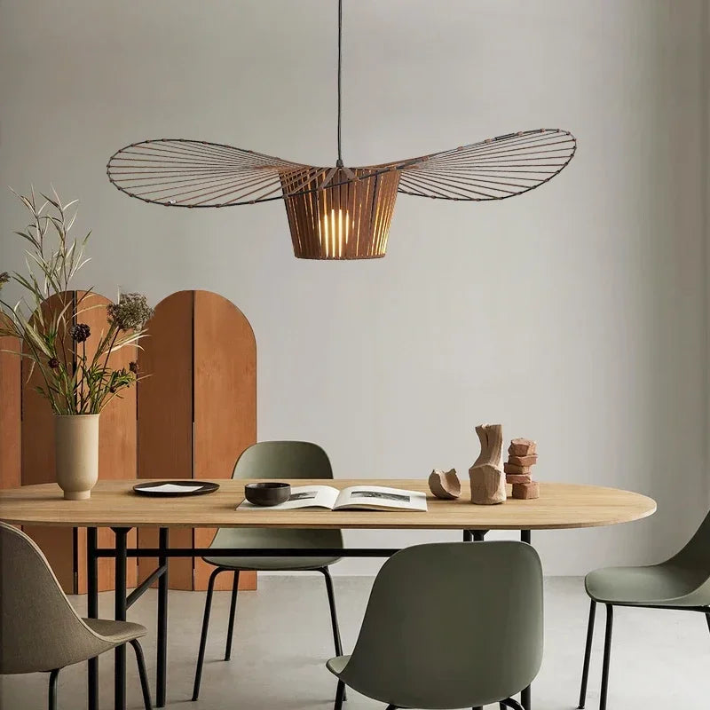 Dining area with a wooden table, chairs, and a modern pendant light.