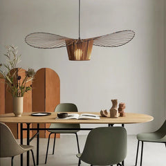 Dining area with a wooden table, chairs, and a modern pendant light.