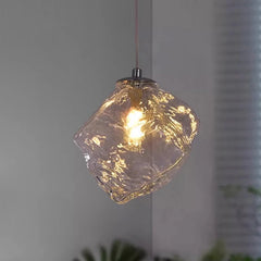 Glass pendant light with a textured design on a neutral background