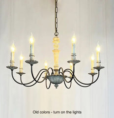 Vintage-style chandelier with multiple candle-like lights on a white background