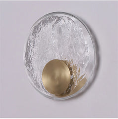 Decorative wall light fixture with gold accent on a gray background