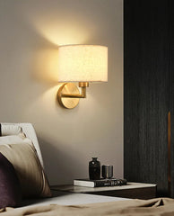 Wall-mounted lamp in a bedroom setting with a cozy ambiance