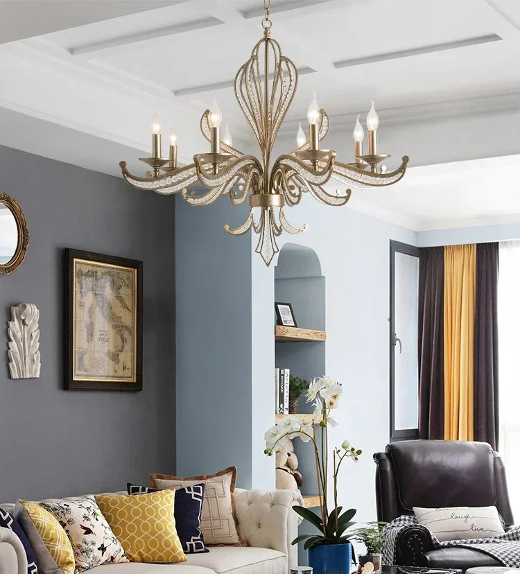 Living room with a chandelier, gray walls, and a sofa with decorative pillows.