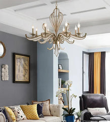 Living room with a chandelier, gray walls, and a sofa with decorative pillows.