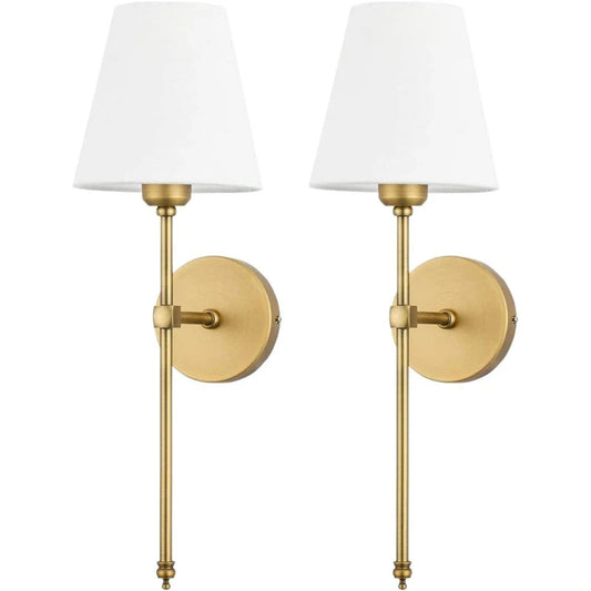 Two brushed gold wall sconces with white fabric shades against a white background.