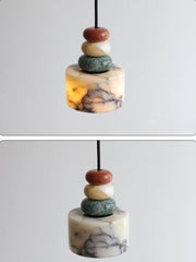 Marble-textured pendant with stacked stones on a white background