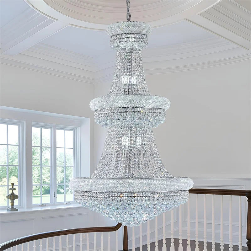 Crystal chandelier hanging in a room with white walls and windows.