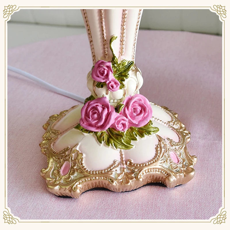 Decorative item with pink roses and gold detailing on a pink background