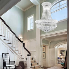 Luxurious staircase with a crystal chandelier in a home interior.